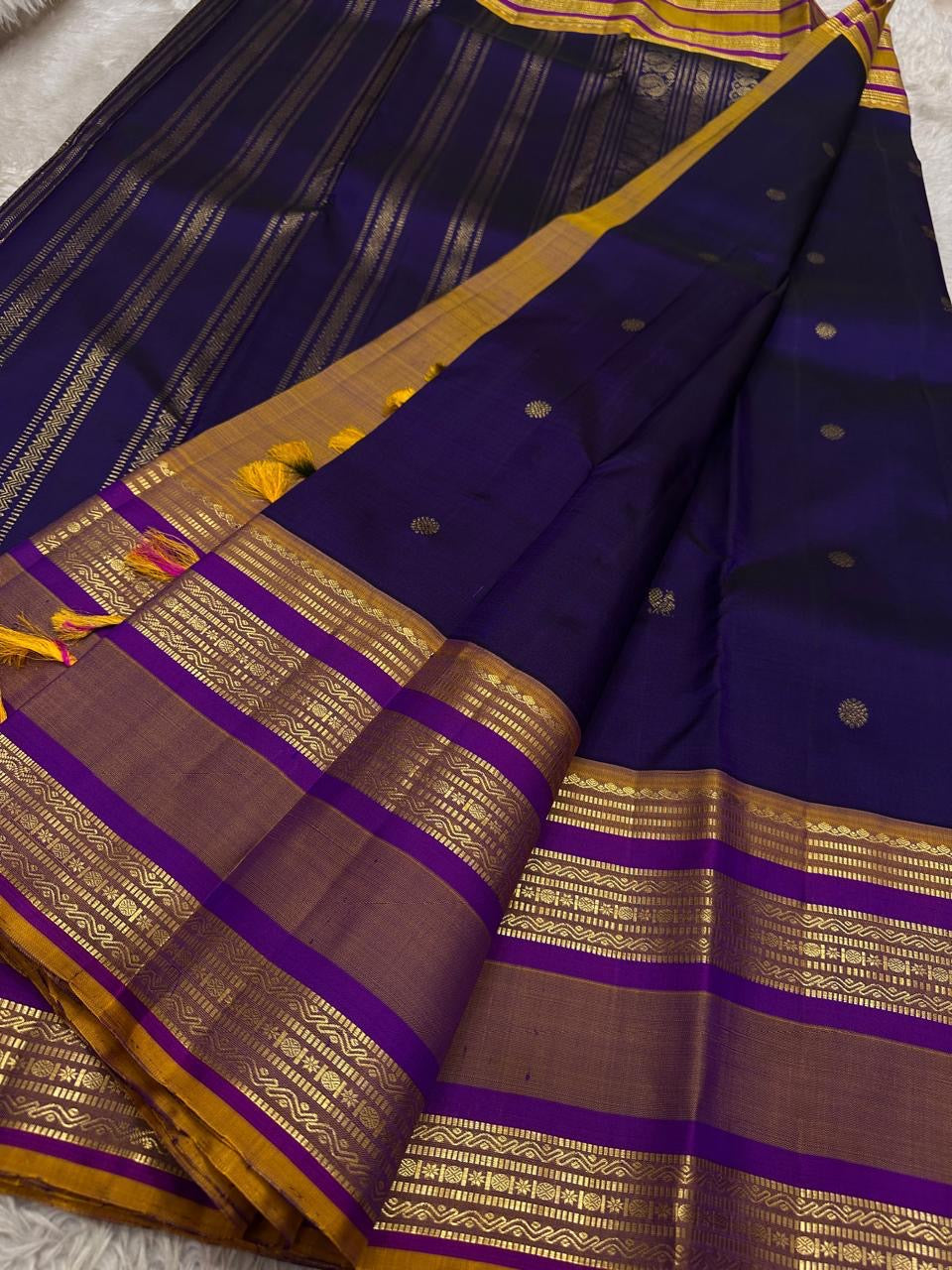 Swarna Laya — Pure Silk Kanchipuram Saree
Deep vaadamalli purple with gold zari buttas, antique-gold border, and rich striped pallu.
Silk Mark Certified • Free USA Shipping • Ships in Two Weeks.