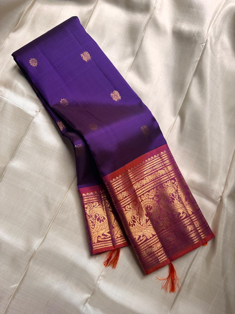 Royal purple and orange red double shade shot color Pallu pure silk Kanchipuram with ornate border featuring Peacock motifs