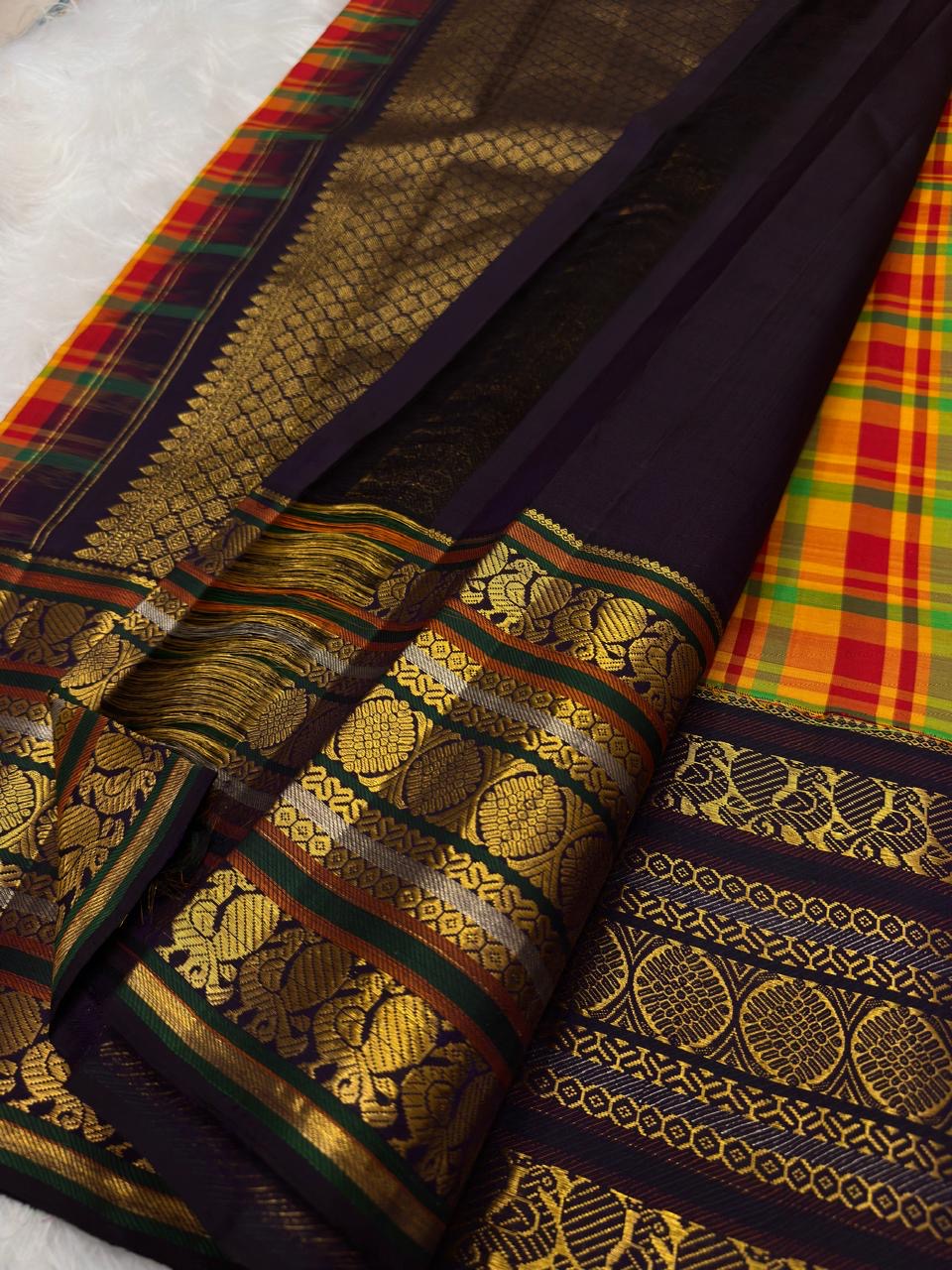 Full folded view of multicolour Kancheepuram Varisaipet saree showing check body and forest green border