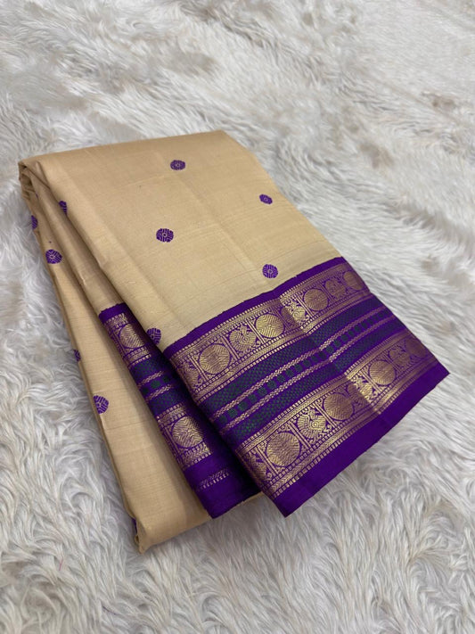 Close view of the ivory gold silk body showing Kamalam Butta in wisteria purple silk thread scattered across the full length