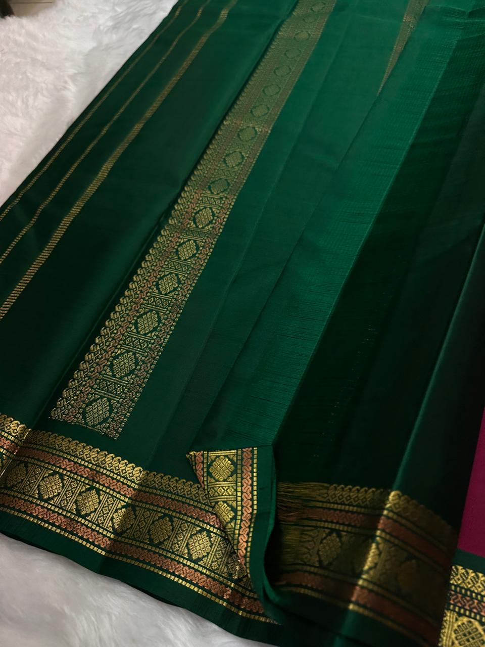 Folded view of the handwoven deep maroon and teal Kanchipuram lightweight Korvai silk saree showing Floral Butta body and Vanasringaram border