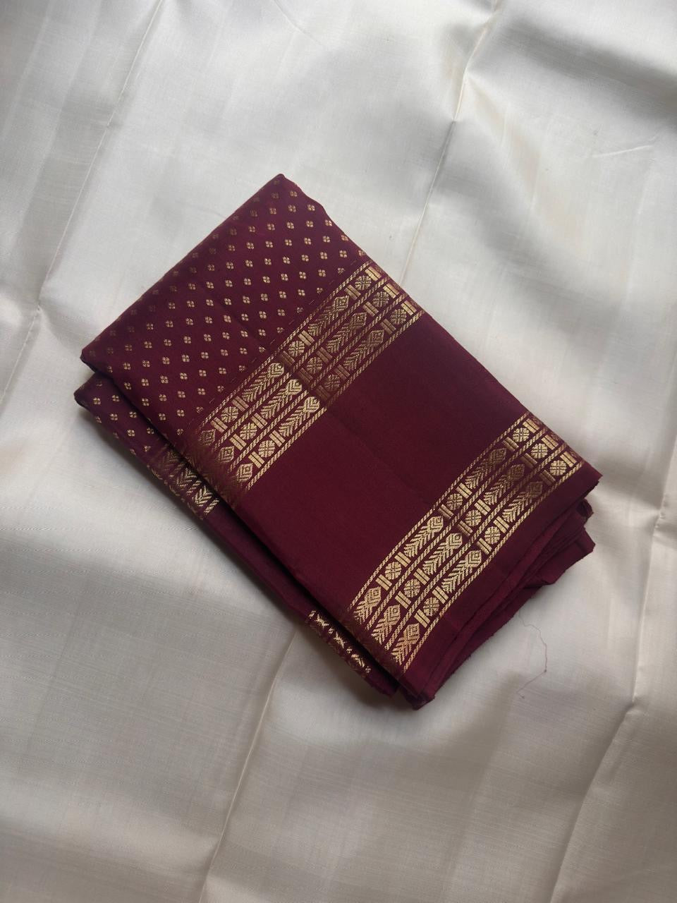 Antique gold geometric zari chevron detail in burgundy Rettapet border — Kanjipuram handwoven silk