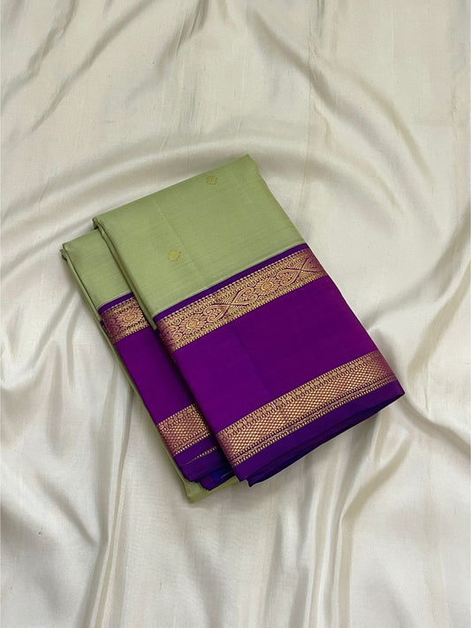 Close-up of pistachio green mulberry silk body with gold zari Kamalam butta on Kanjivaram saree