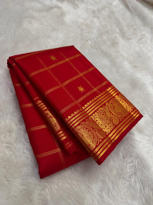 Close-up of deep red mulberry silk body with gold zari Zari Kattam intersecting grid