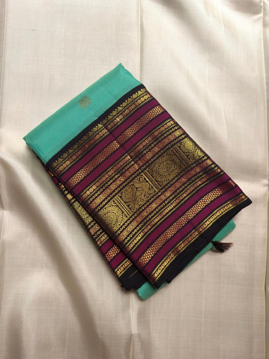 Aqua Turquoise pure silk Kanjipuram Butta saree with deep navy, magenta and gold zari border.