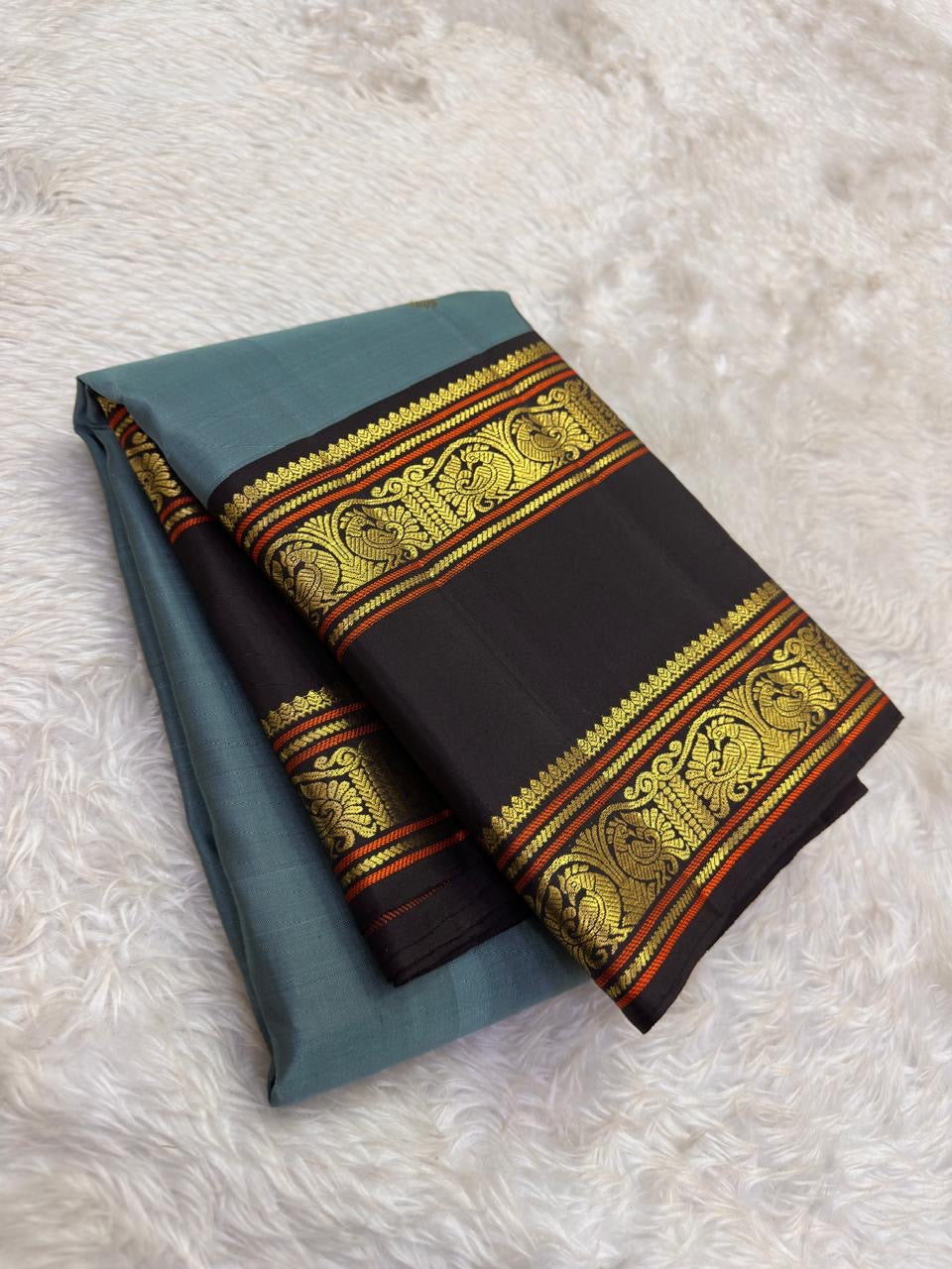 Ash blue Kanjivaram silk saree with cocoa brown korvai rettapet border folded display Idam Living