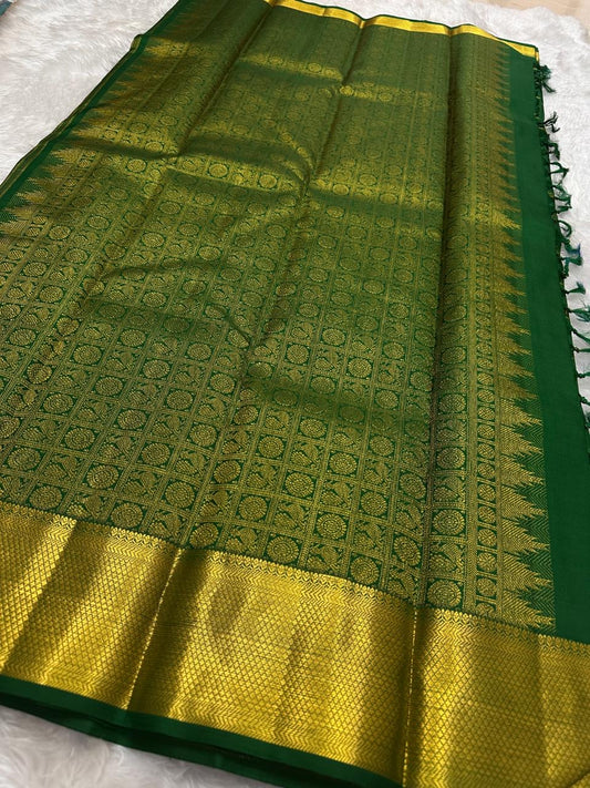 Broad gold zari border with textured field on the emerald green saree.
