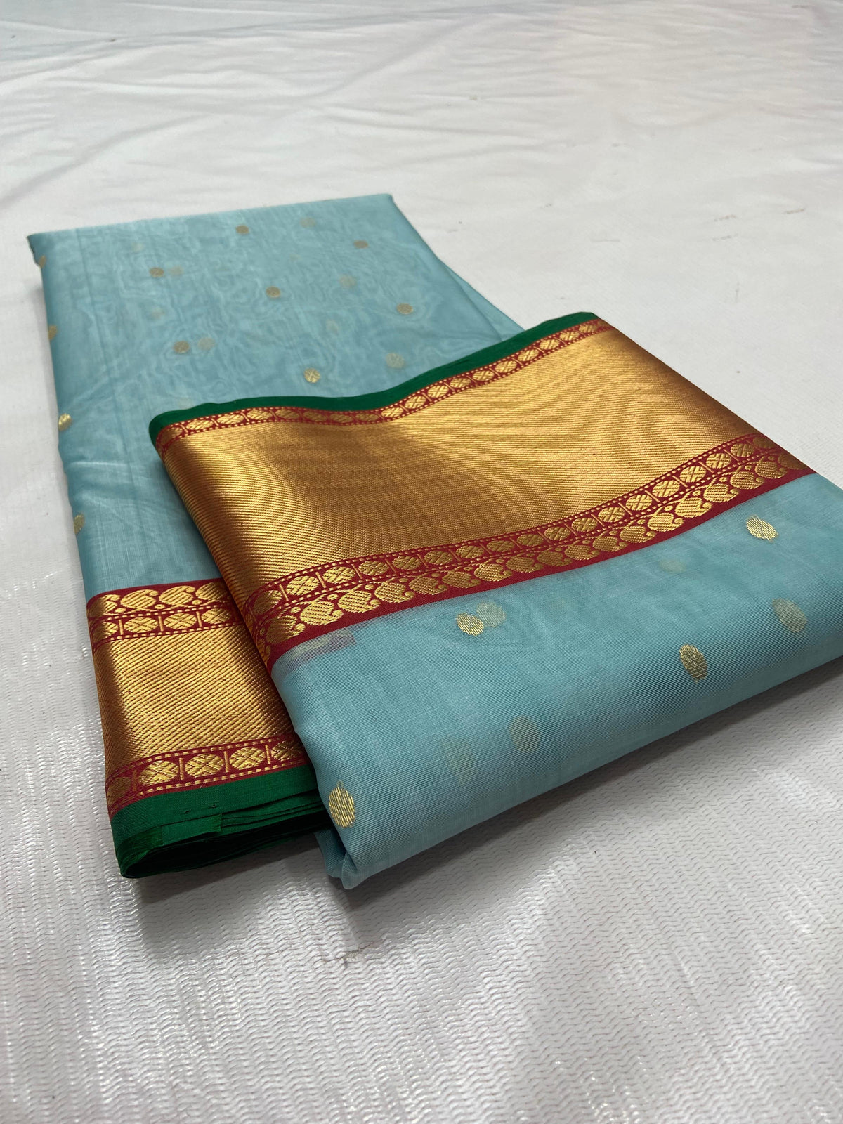 Blue Chanderi saree with gold buttas and red border detail