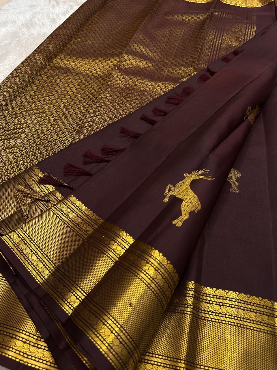 Close view of bounding deer motif handwoven on deep brown Pure Silk Kancheepuram saree