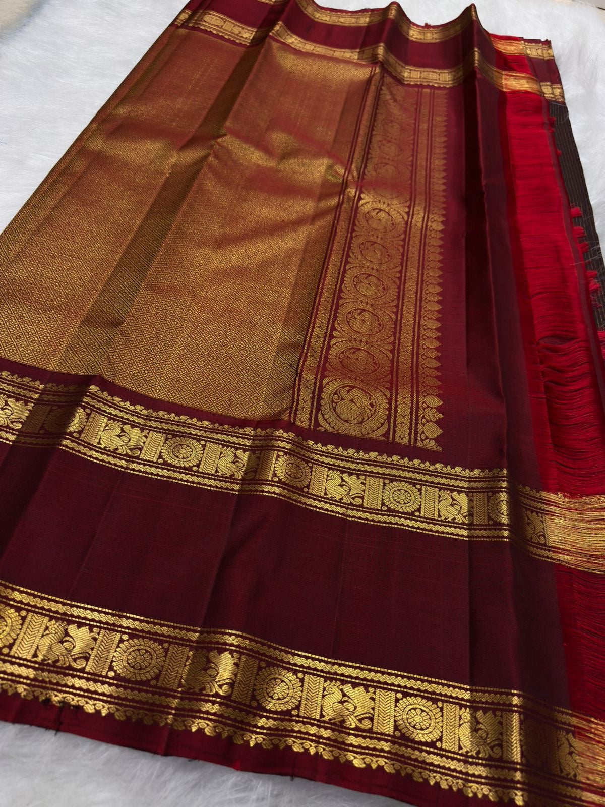 Deep brown Kanchipuram silk with fine Zari Kattam lines and scattered traditional gold zari motifs.