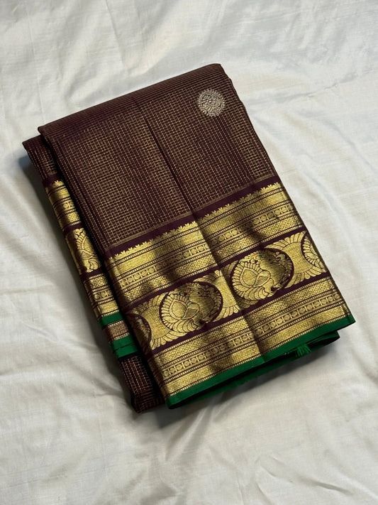 Gold zari peacock-paisley pallu detail on brown Zari Kattam saree