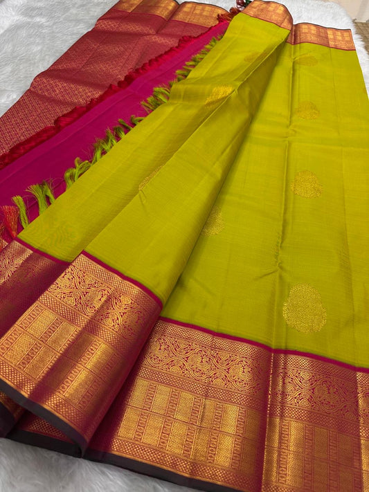Chartreuse green Kanjeevaram silk saree showing flower butta on body and magenta Korvai border — Idam Living