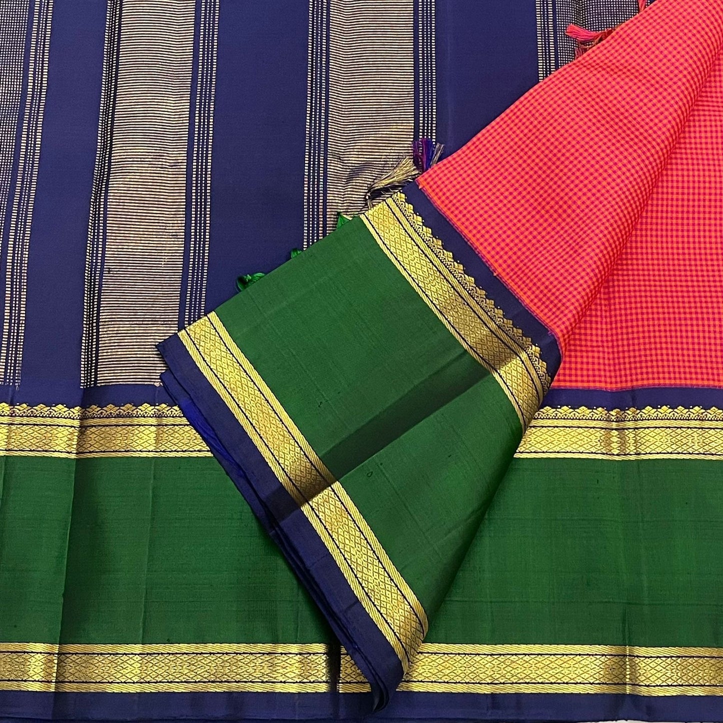 Pure Kanchipuram silk saree pallu detail in navy with vertical zari stripes, paired with green border and gold zari bands.