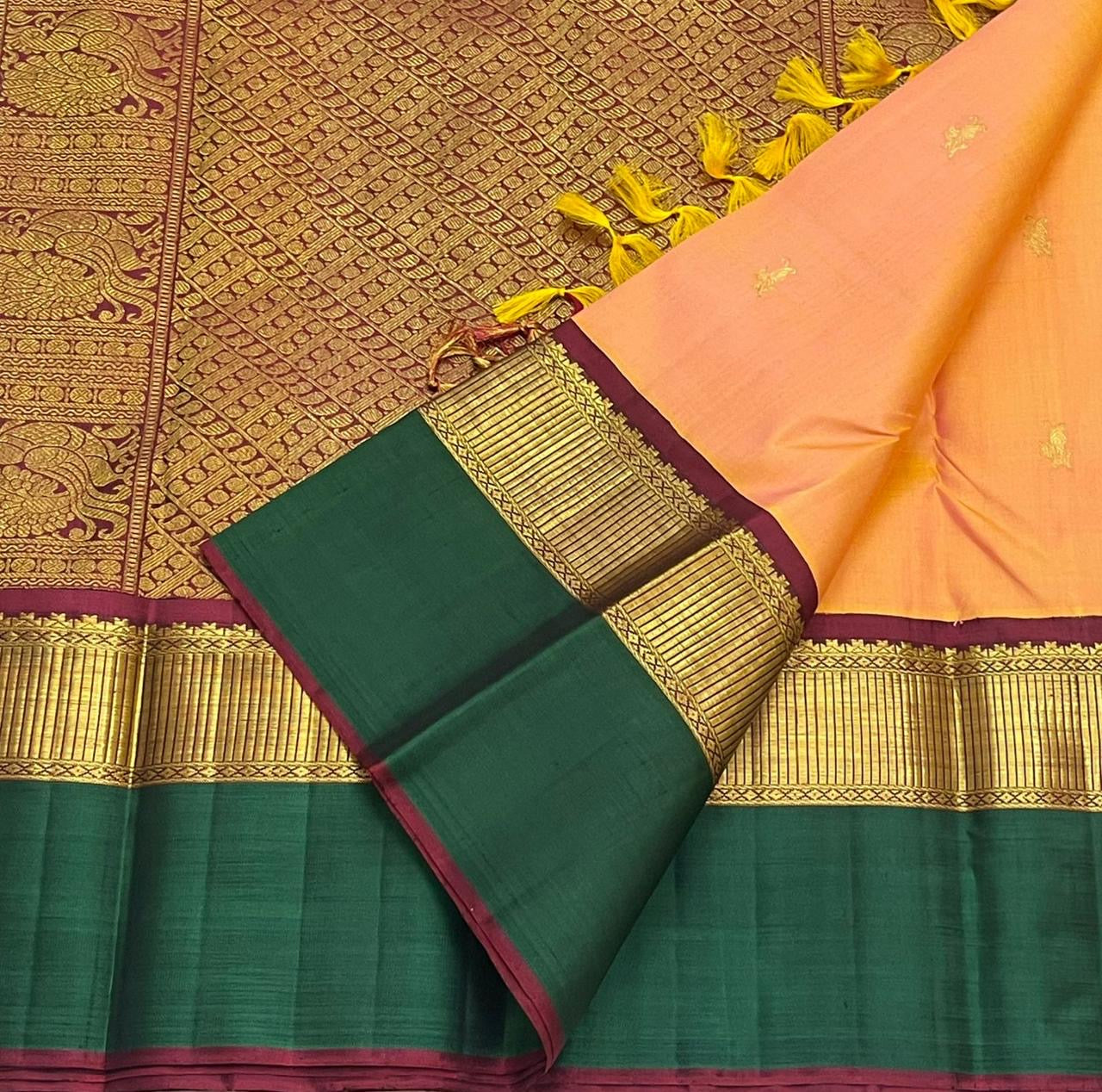 Detailed border view of Kanchipuram silk saree with green silk edge, maroon selvedge, and antique gold zari work