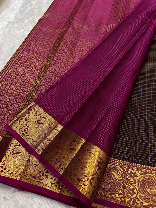 Coffee brown silk body next to the deep pink border featuring gold zari Thogai Mayil peacock motifs