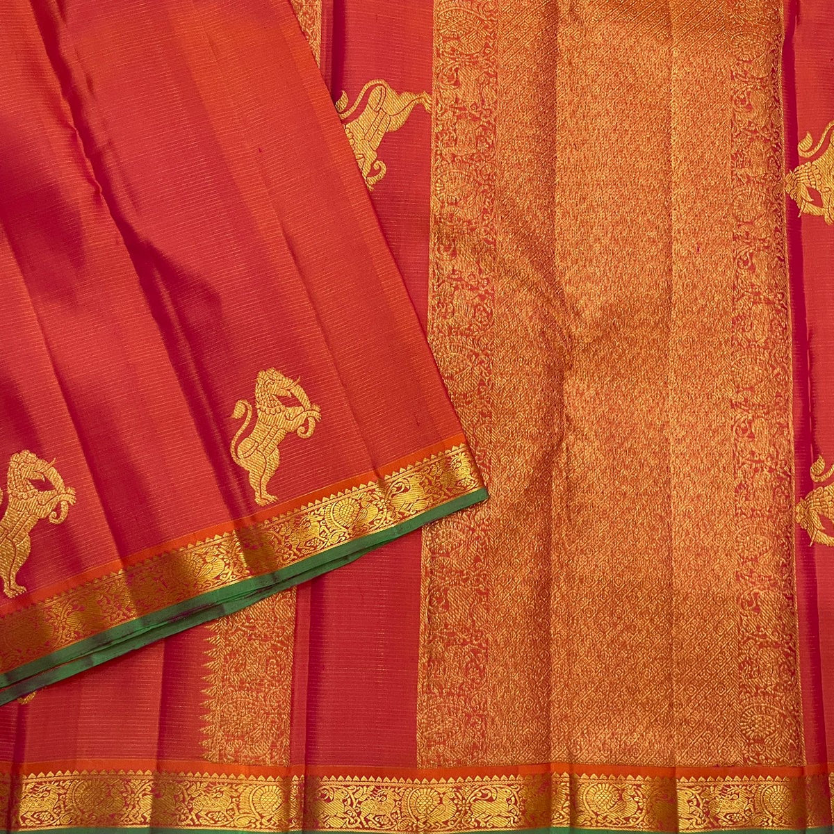 Close view of large handwoven Yazhi motif in warm gold zari on radiant Coral Rose silk.