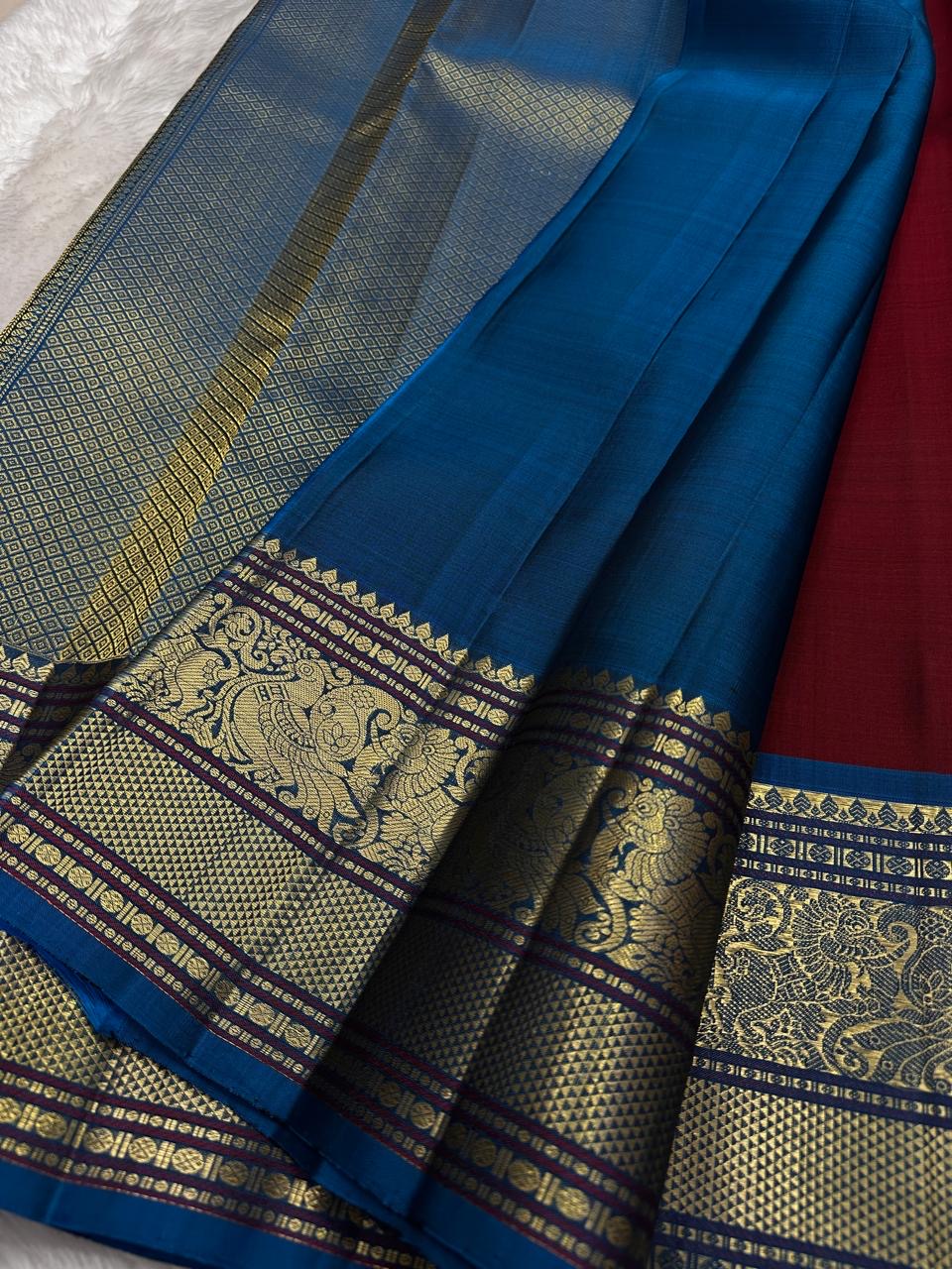 Crimson Maroon Kanchipuram Silk Saree with Peacock Blue Korvai Mayil Border