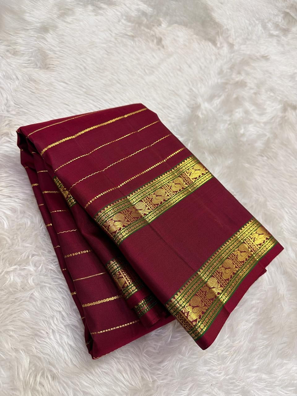 Deep Arakku Red pure silk Kanchi Pattu Rettapet saree with lengthwise Veldhari gold zari.