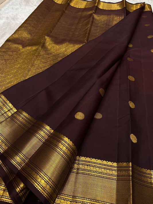 Full view of deep brown Kanjivaram Butta saree showing evenly spaced coin-inspired Pavun motifs