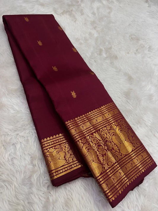Deep arakku Kanjivaram silk saree with rich antique gold zari border detailing