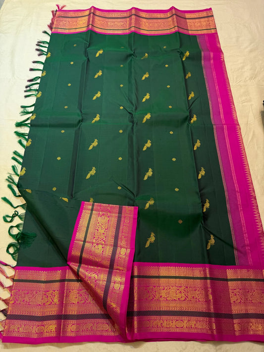 Deep emerald green Kanjeevaram silk saree with gold zari mayil peacock butta on body — Idam Living