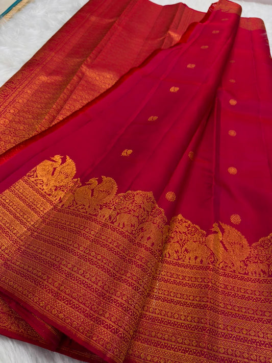 Deep Maroon Kanjivaram silk saree body close-up with gold zari floral butta motifs
