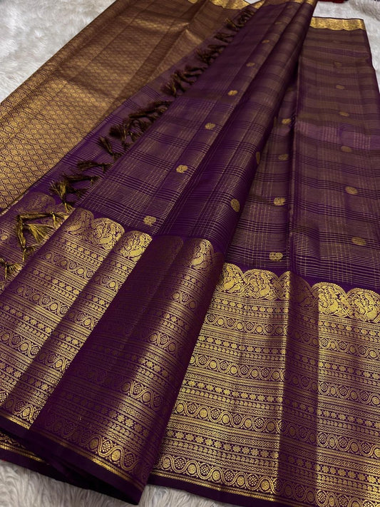 Layered classic-gold ornamental border against deep purple Kanchipuram silk.