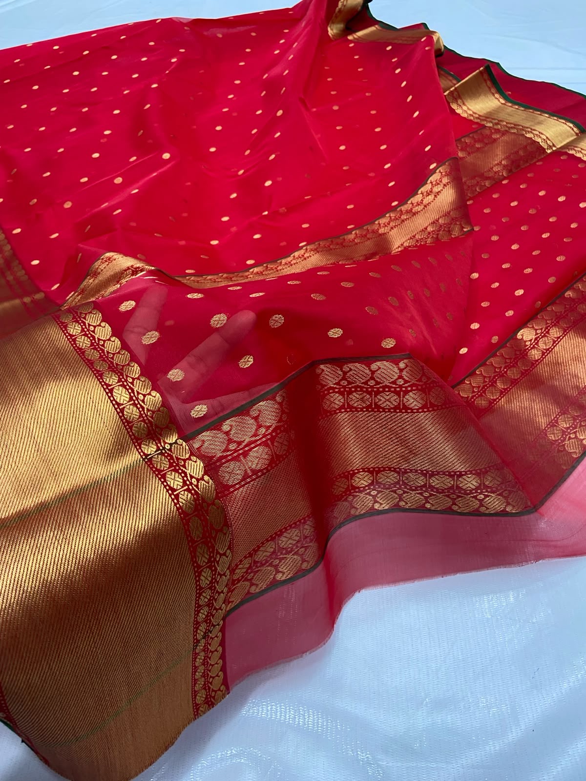 Deep red Chanderi saree showing gold butta detail