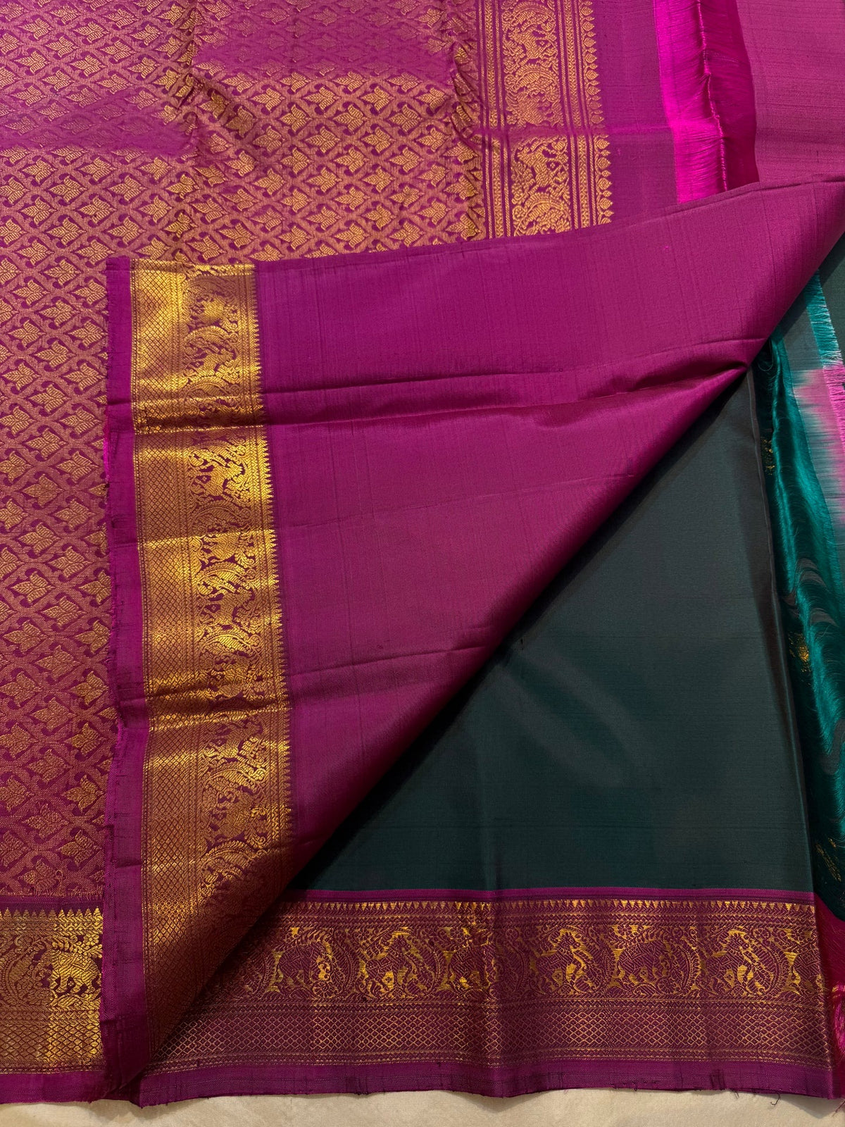 Figurative gold-zari detailing against saturated Pink silk.