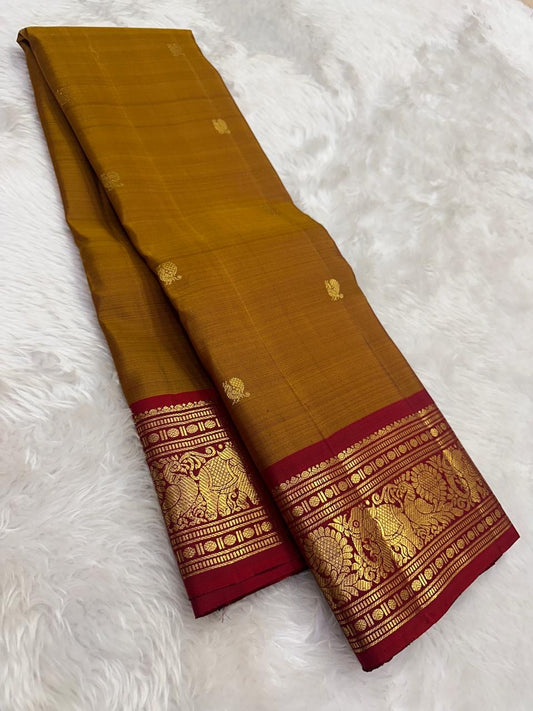 Kanchipattu silk saree in korvai with earthy mustard yellow border weave traditional zari detail
