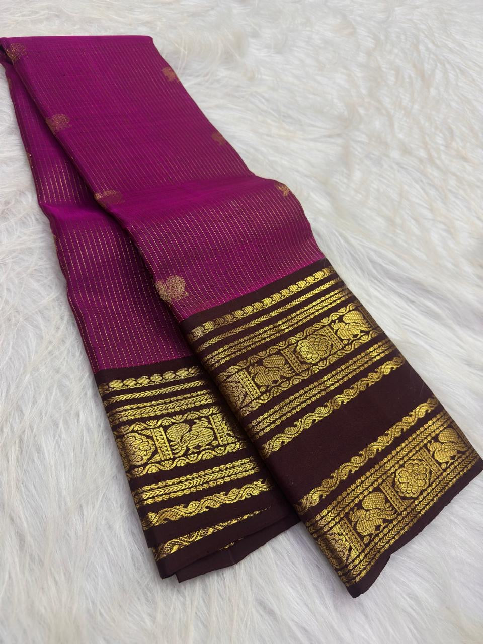 Deep brown pallu with closely packed gold diamond checks and floral zari work on a Vadamalli pink Kanjipuram saree