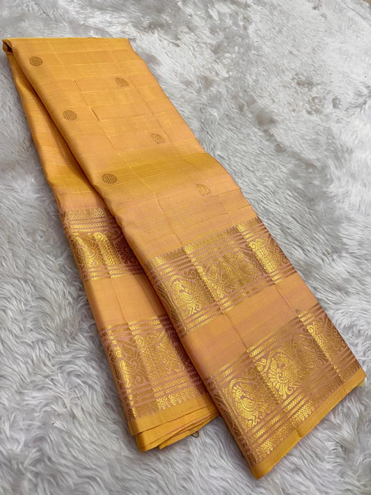 Elegant Kanjivaram silk saree in soft wheat gold with traditional woven motifs