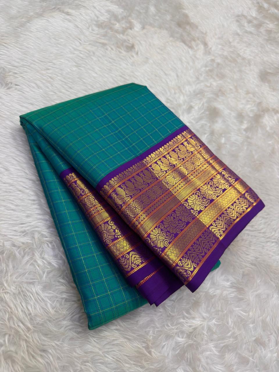 Handwoven pure silk Korvai saree from Kanchipuram with teal blue and royal purple interlocked weaving