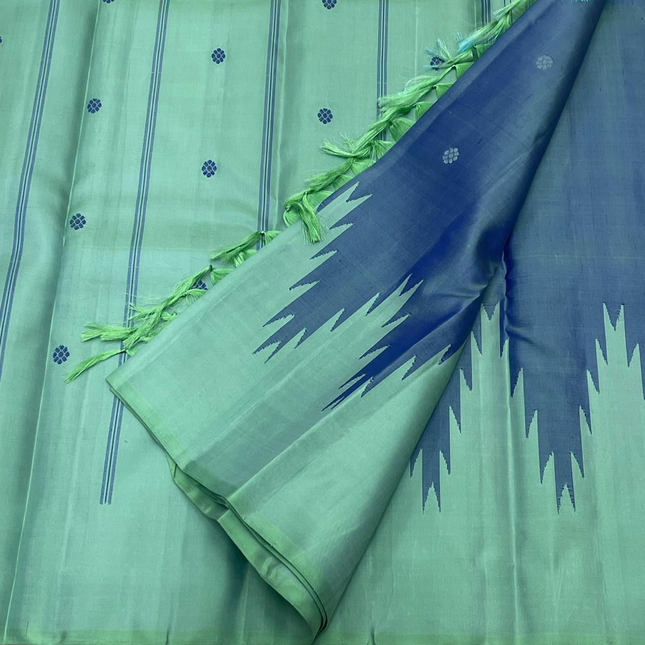 Mint Pure Kanchipuram silk saree body with vertical stripes and small dot motifs alongside deep blue section