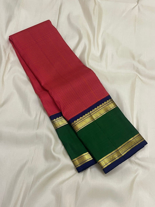 Long folded view of red checked pure Kanchipuram silk saree with green border section, navy edge, and gold zari detailing.