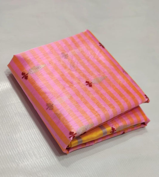 Close view of pink and mango striped silk fabric with small woven butti and yellow border.