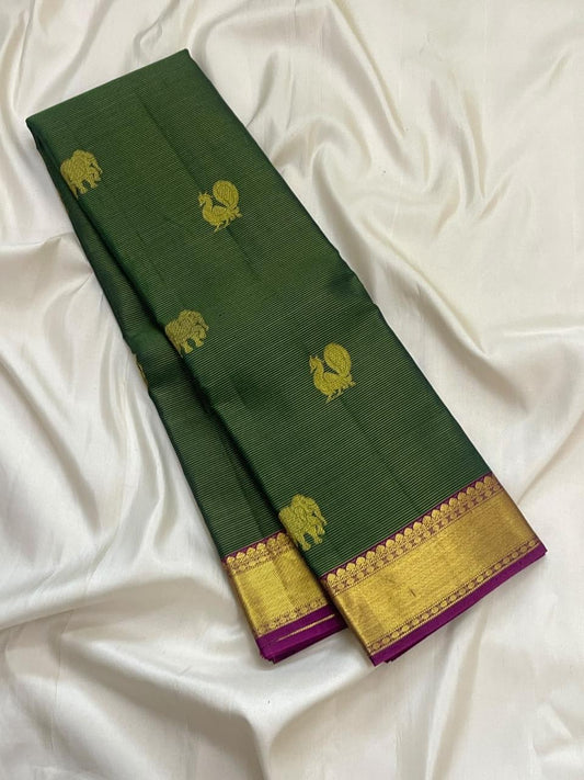 Broad gold zari border with magenta accent on forest-green Kanjivaram silk