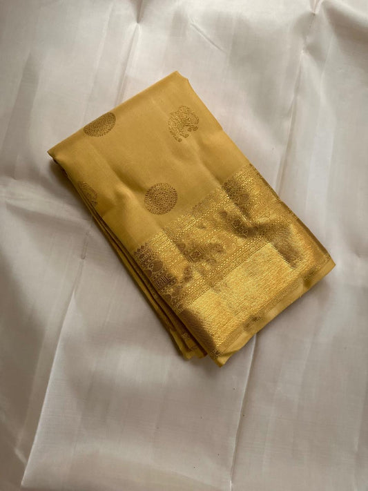 Broad Varisaipet border with ornate handwoven gold zari motifs on Butter Yellow silk