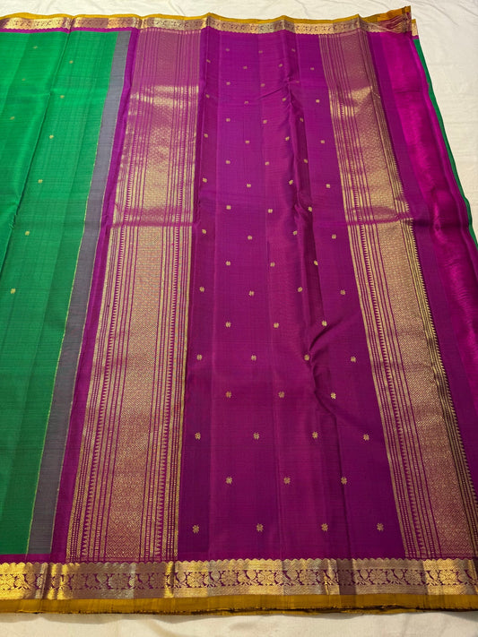 Close-up of Kamalam Butta gold-zari motifs on green Kancheepuram silk body