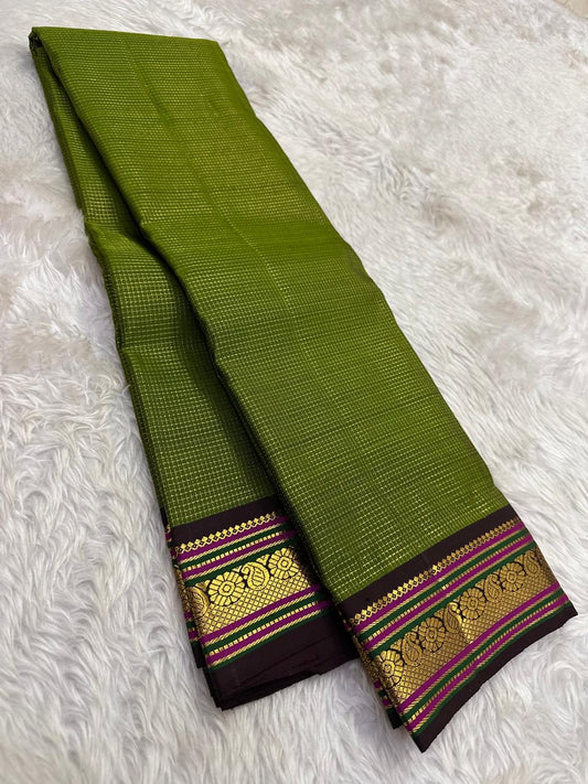 Earthy green Kanjivaram silk saree with traditional zari woven small korvai border detail