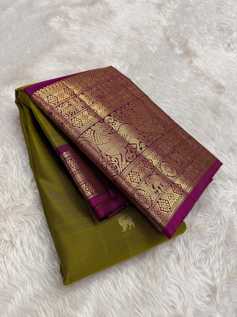 Authentic Kancheepuram silk saree with forest olive body and vivid rani magenta Yazhi border detailing