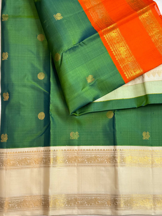 Double-shot leaf-to-emerald green with golden-mustard light pure silk Kanchipuram saree, orange ivory kanchipuram ganga jamuna; traditional Rettapet weave.