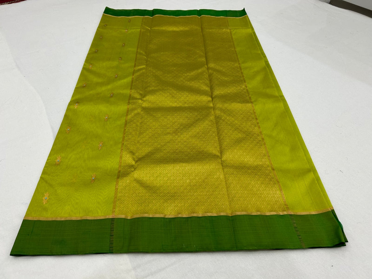 Close-up of the wide Forest Green silk border with fine gold edging on a Lime Green Pattu Silk Chanderi saree