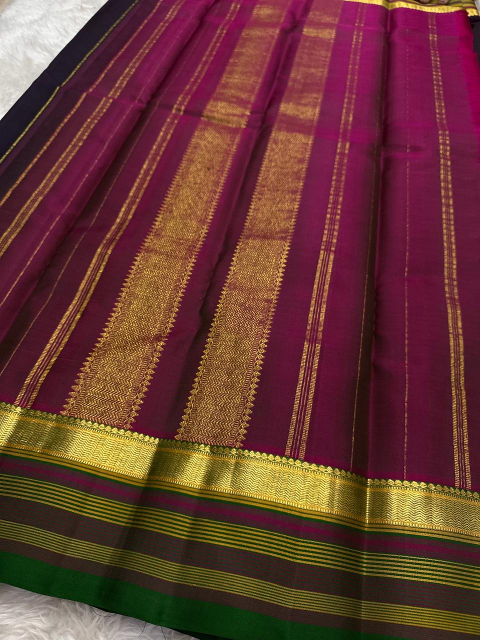 Gold zari buttas on deep black Kanchipuram silk.