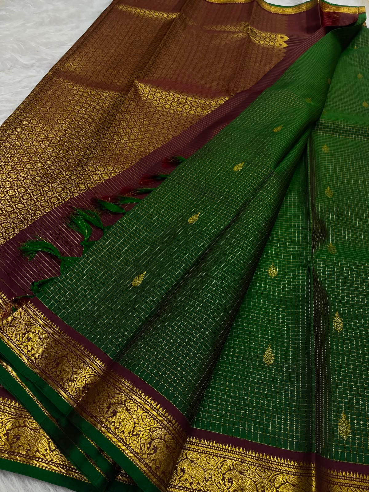 Deep forest-green pure silk Kanchipuram Zari Kattam saree, folded view — Idam Living