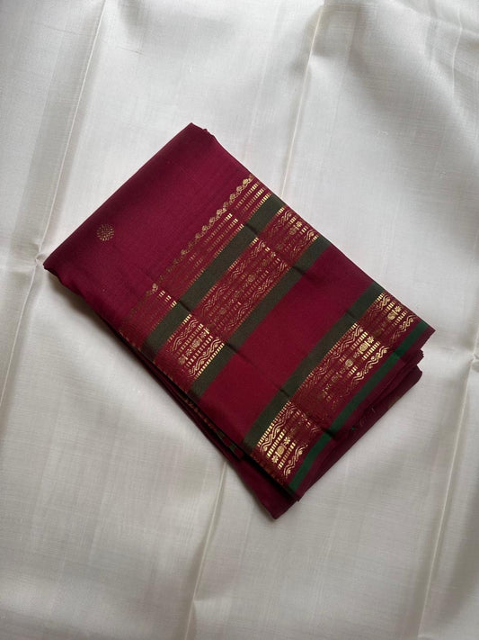 Close-up of gold zari buttas on Deep Raspberry Red Kanchi Pattu silk saree body
