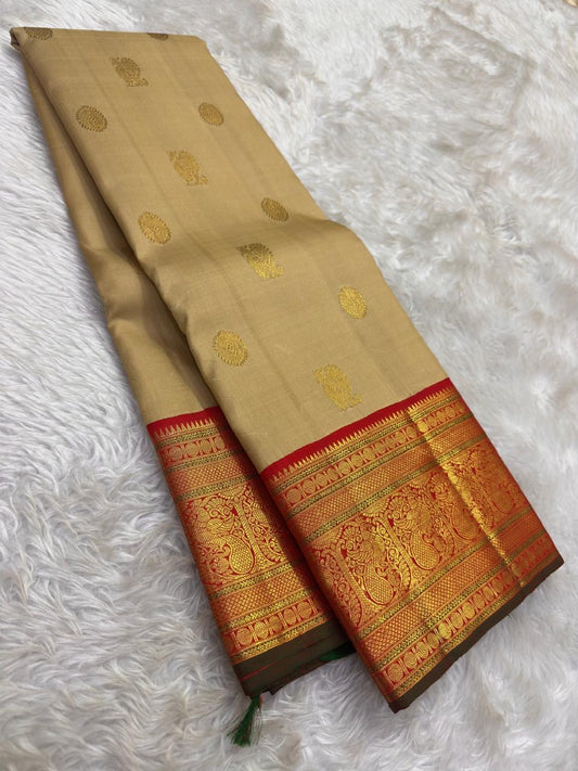 Pure Kanjivaram silk saree with mayil chakram buttas and antique gold zari detailing
