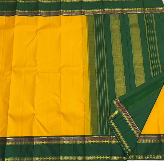 Yellow Pure Kanchipuram silk saree featuring classic rudhraksham butta motifs with mustard green rettapet zari border