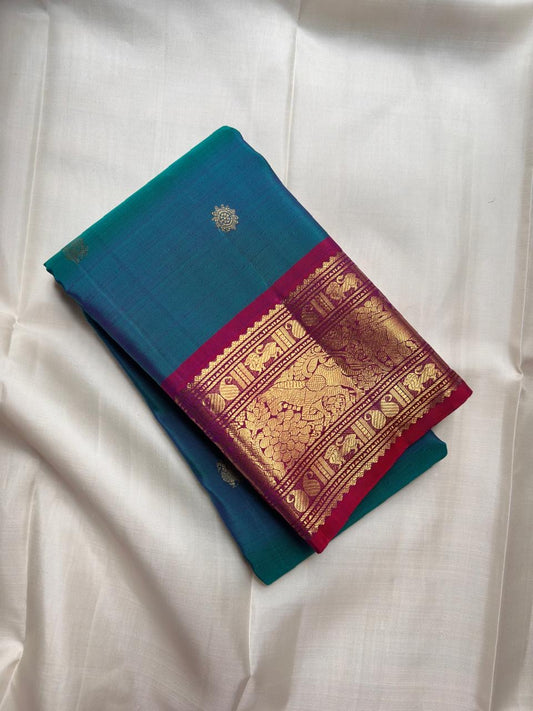 Handwoven sapphire blue Kanjeevaram saree with deep raspberry red Korvai border.