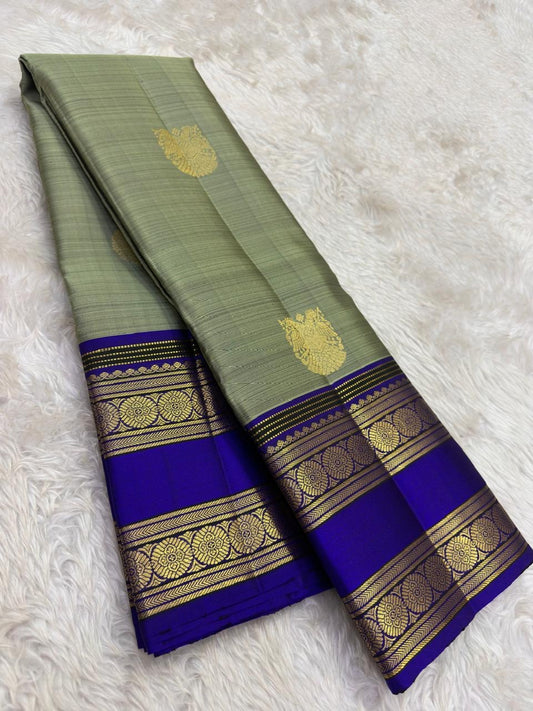 Sage green Kanchipuram saree with Gandaberunda buttas and Rettapet border — Idam Living.